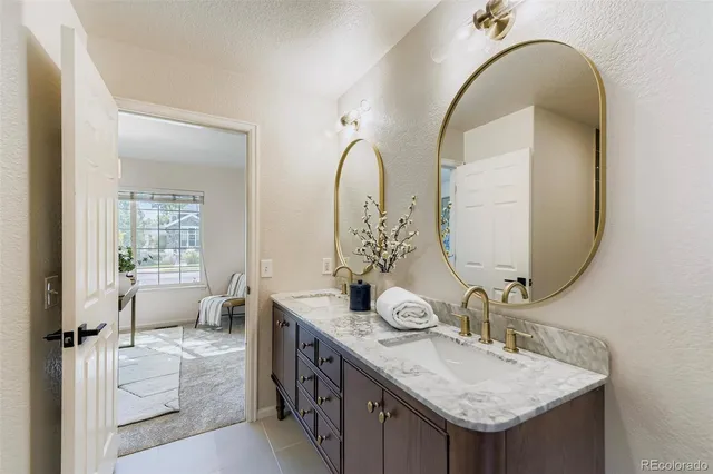 a bathroom with a double vanity sink and a mirror