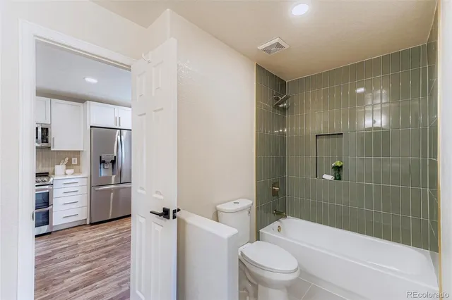 a bathroom with a granite countertop toilet sink and shower