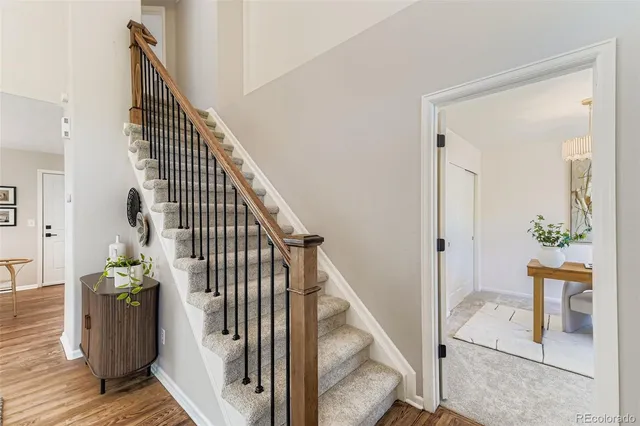 a view of a hallway with wooden floor and entryway