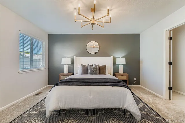 a bedroom with a bed and a table