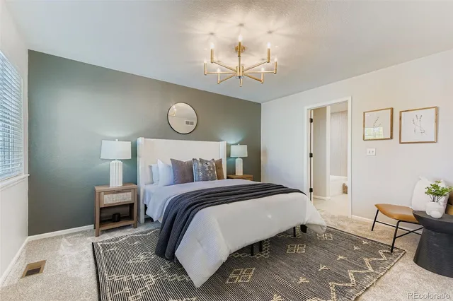 a bedroom with a bed and a table with chair