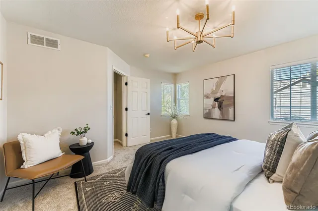 a bedroom with a bed and a chandelier