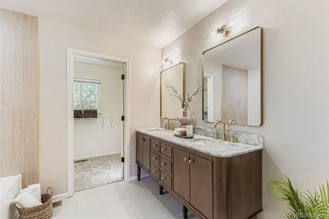 a bathroom with a double vanity sink and a mirror
