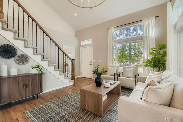 a living room with furniture and a painting on the wall