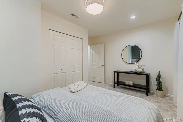a bedroom with a bed and a mirror