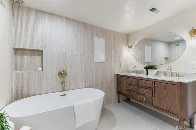 a bathroom with a tub sink and mirror