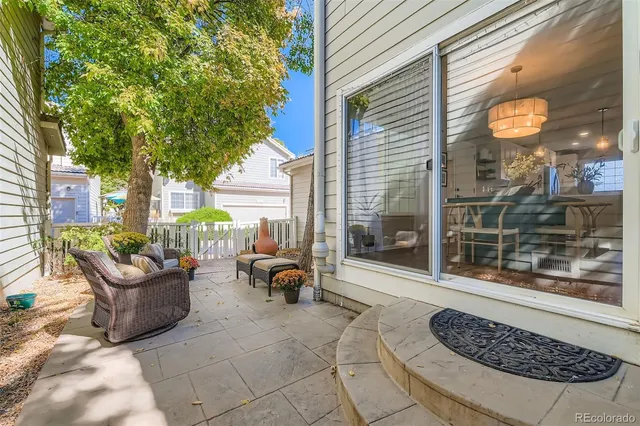a view of a white house with a yard and plants