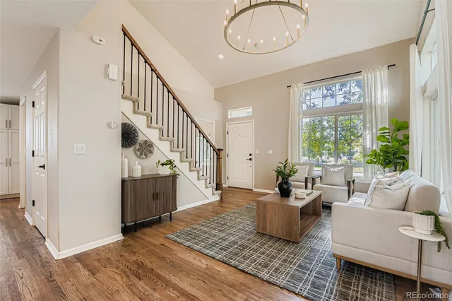 a living room with furniture and wooden floor