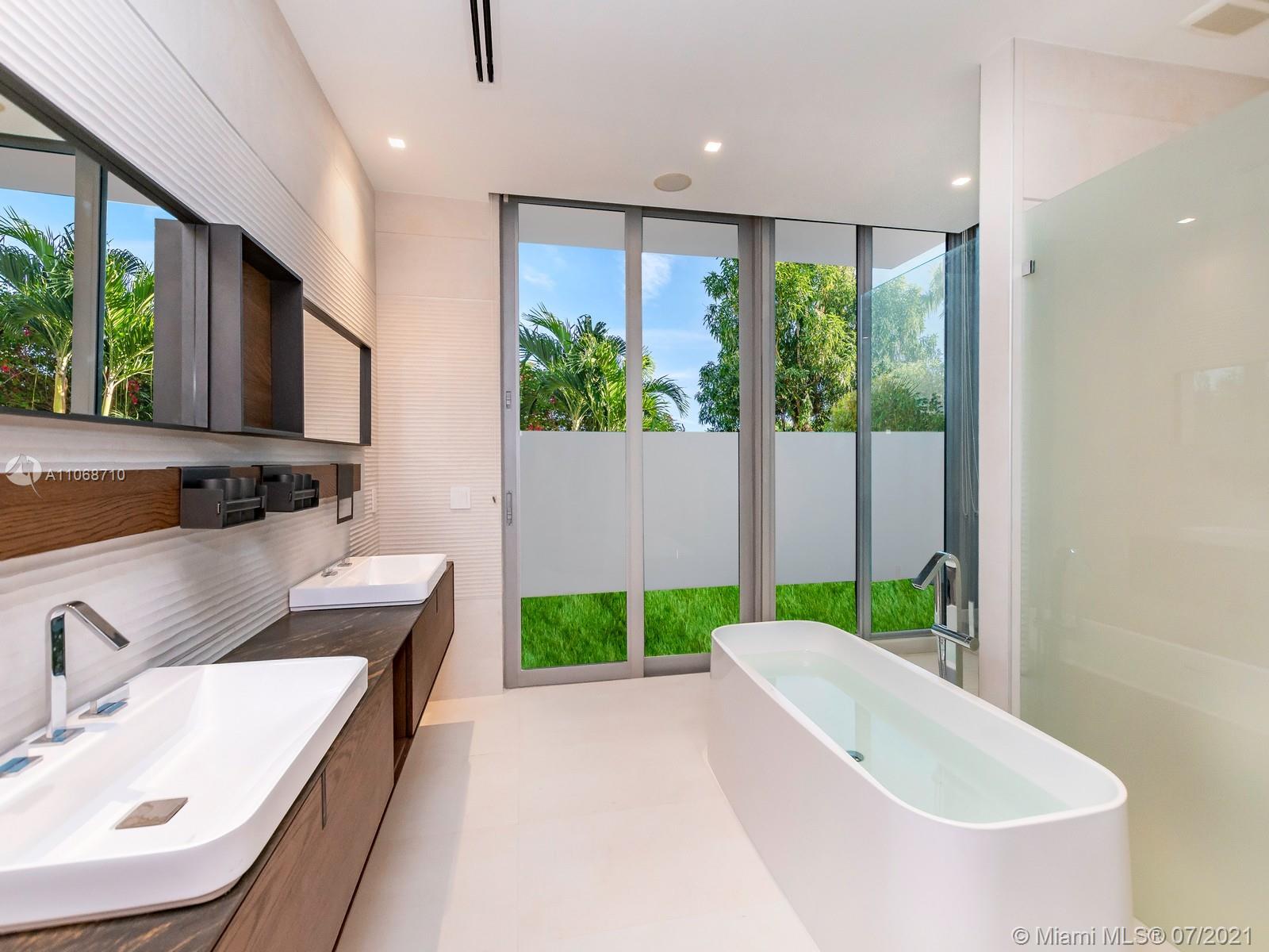 761 Glenridge Road Key Biscayne, FL 33149 - Photo 12 of 19 a bathroom with a sink and a large mirror
