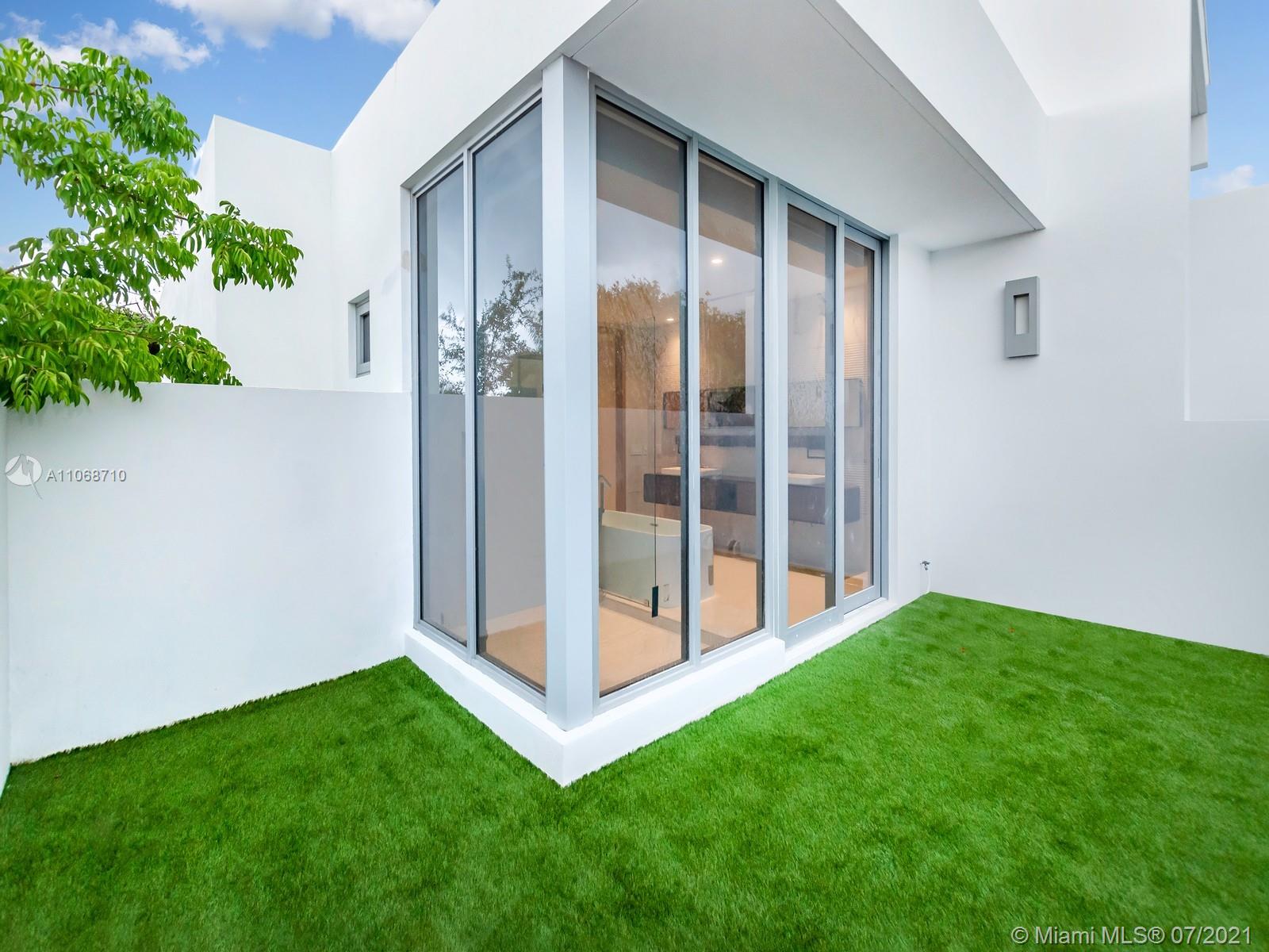 761 Glenridge Road Key Biscayne, FL 33149 - Photo 14 of 19 a view of backyard with large trees and plants