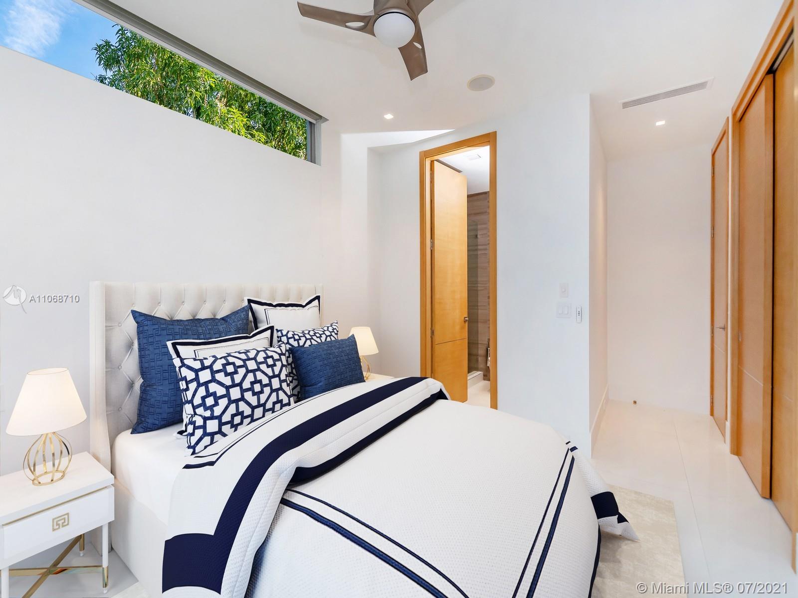 761 Glenridge Road Key Biscayne, FL 33149 - Photo 16 of 19 a bedroom with a bed and a chandelier