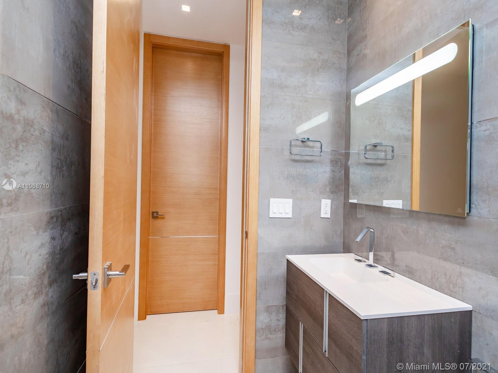 761 Glenridge Road Key Biscayne, FL 33149 - Photo 17 of 19 a bathroom with a sink and a mirror