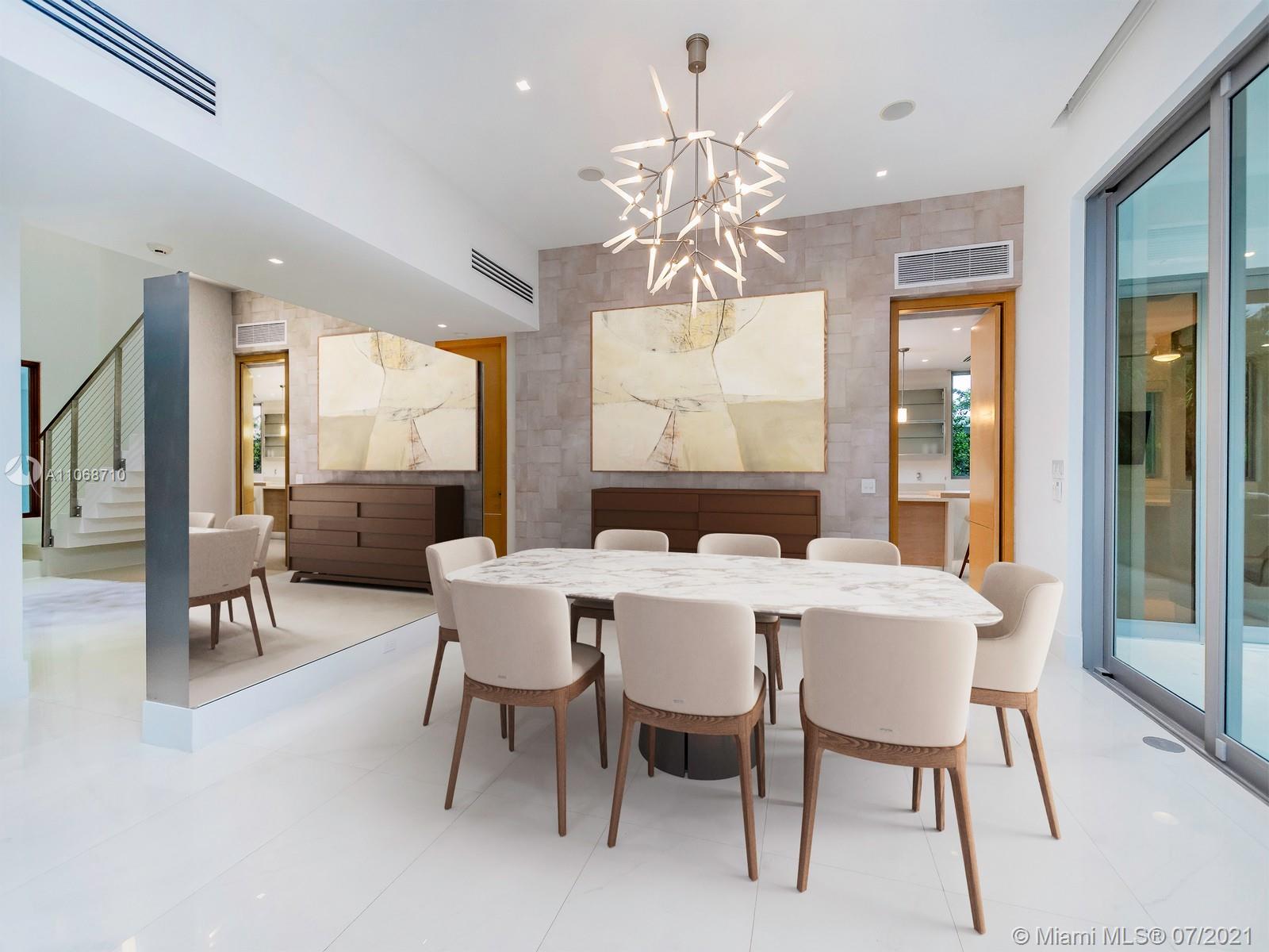 761 Glenridge Road Key Biscayne, FL 33149 - Photo 3 of 19 a view of a dining room with furniture a chandelier and wooden floor