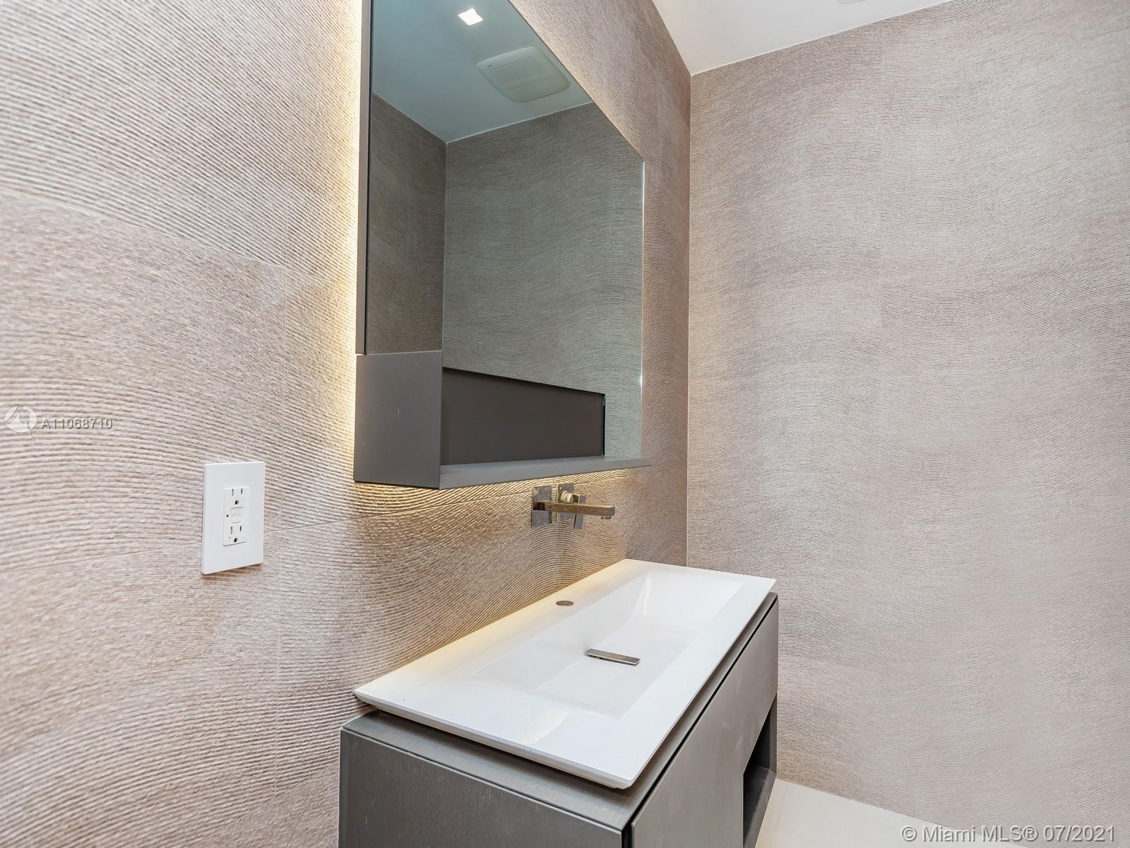 761 Glenridge Road Key Biscayne, FL 33149 - Photo 6 of 19 a bathroom with a sink a mirror and vanity