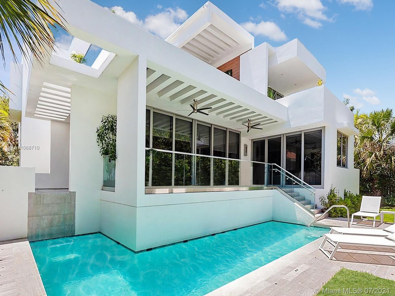 761 Glenridge Road Key Biscayne, FL 33149 - Photo 8 of 19 a view of house with backyard and outdoor seating