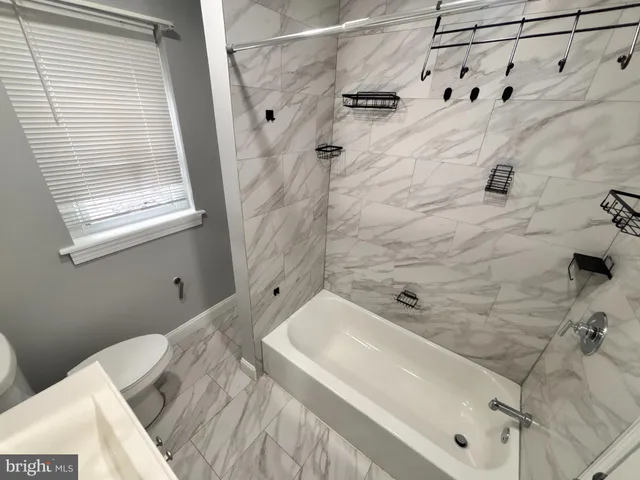 a bathroom with a bathtub and shower