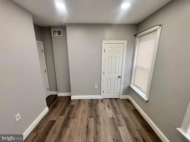 a view of a room with wooden floor