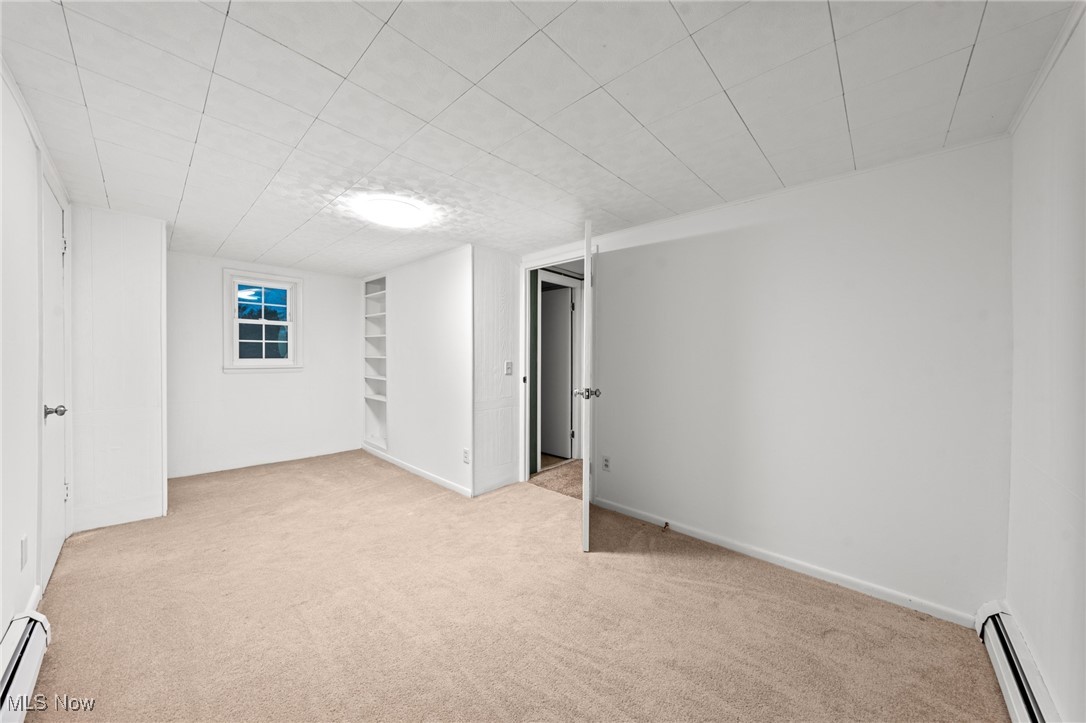 9513 Booth Road Willoughby, OH 44094 - Photo 32 of 45 Spare room with light colored carpet and a baseboard radiator