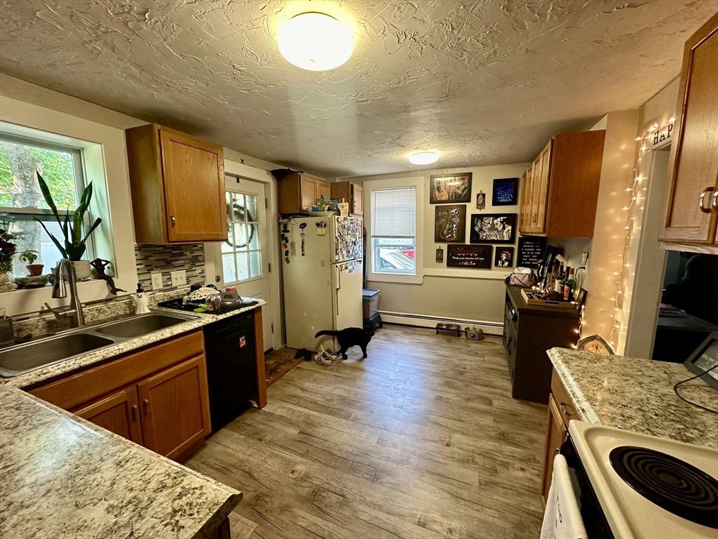 1271 Main Street Leicester, MA 01524 - Photo 13 of 23 a kitchen with sink refrigerator and stove
