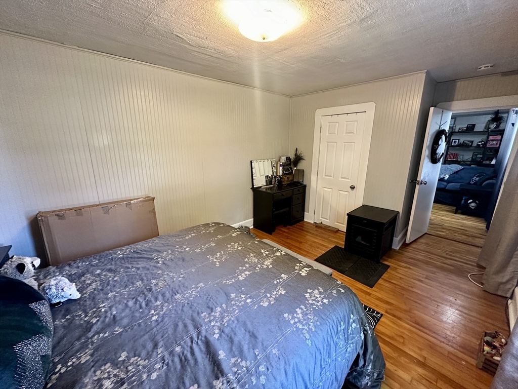 1271 Main Street Leicester, MA 01524 - Photo 17 of 23 a bedroom with a bed and wooden floor