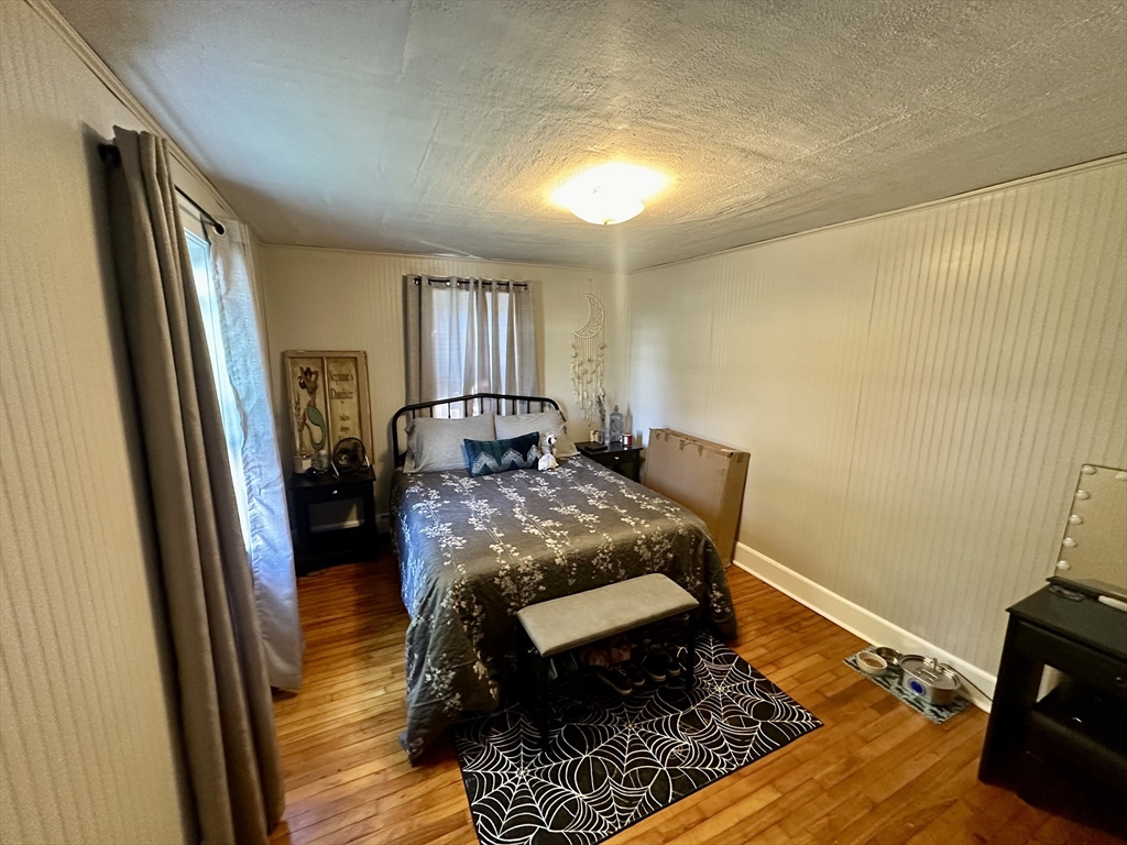 1271 Main Street Leicester, MA 01524 - Photo 18 of 23 a bedroom with a bed and wooden floor