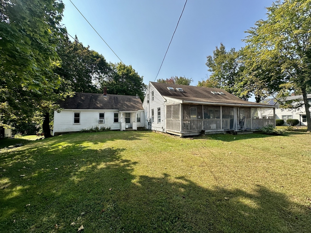 1271 Main Street Leicester, MA 01524 - Photo 3 of 23 a front view of a house with a yard table and chairs