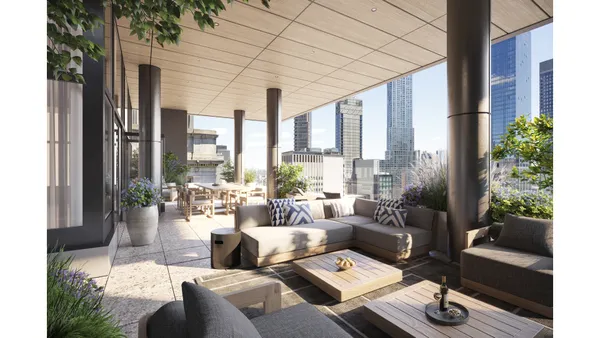 a view of living room filled with furniture and floor to ceiling windows