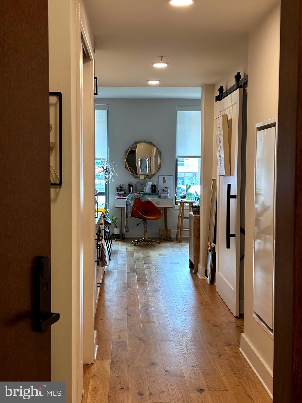 1211 Van Street Southeast, Unit 310 Washington, DC 20003 - Photo 14 of 49 a hallway with a dining table and chairs