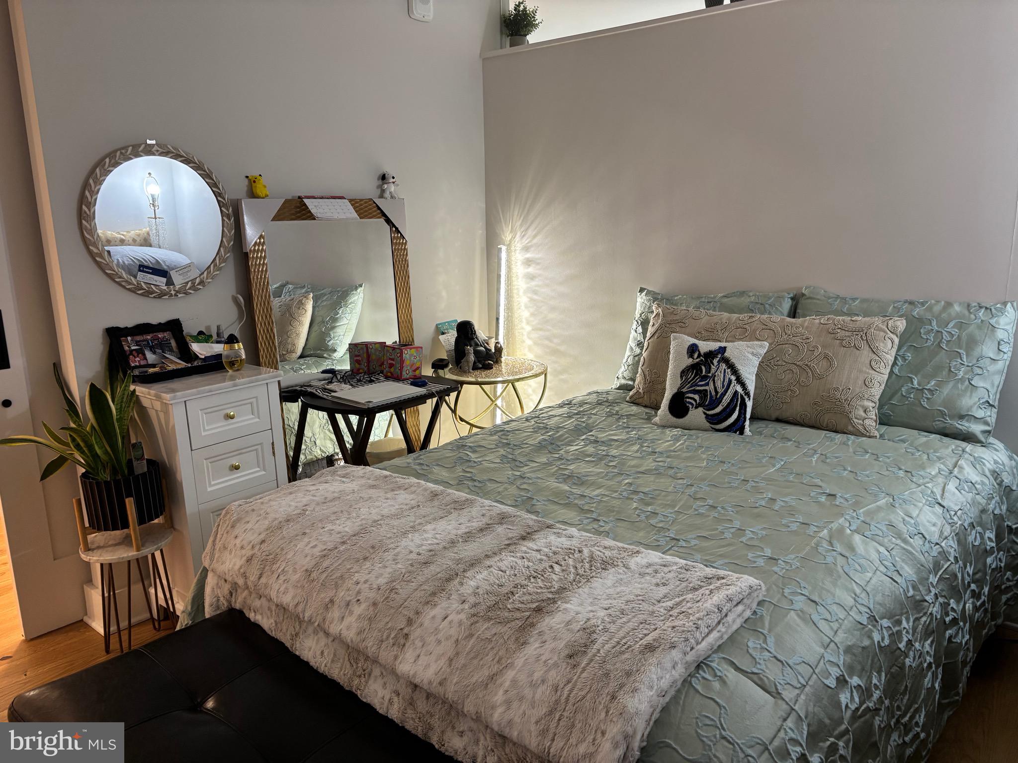1211 Van Street Southeast, Unit 310 Washington, DC 20003 - Photo 19 of 49 a bedroom with a bed a mirror and lamp