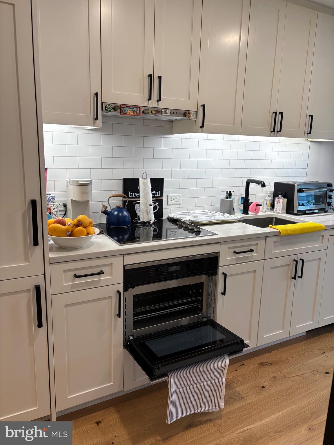 1211 Van Street Southeast, Unit 310 Washington, DC 20003 - Photo 21 of 49 a kitchen with stainless steel appliances a white stove top oven and cabinets