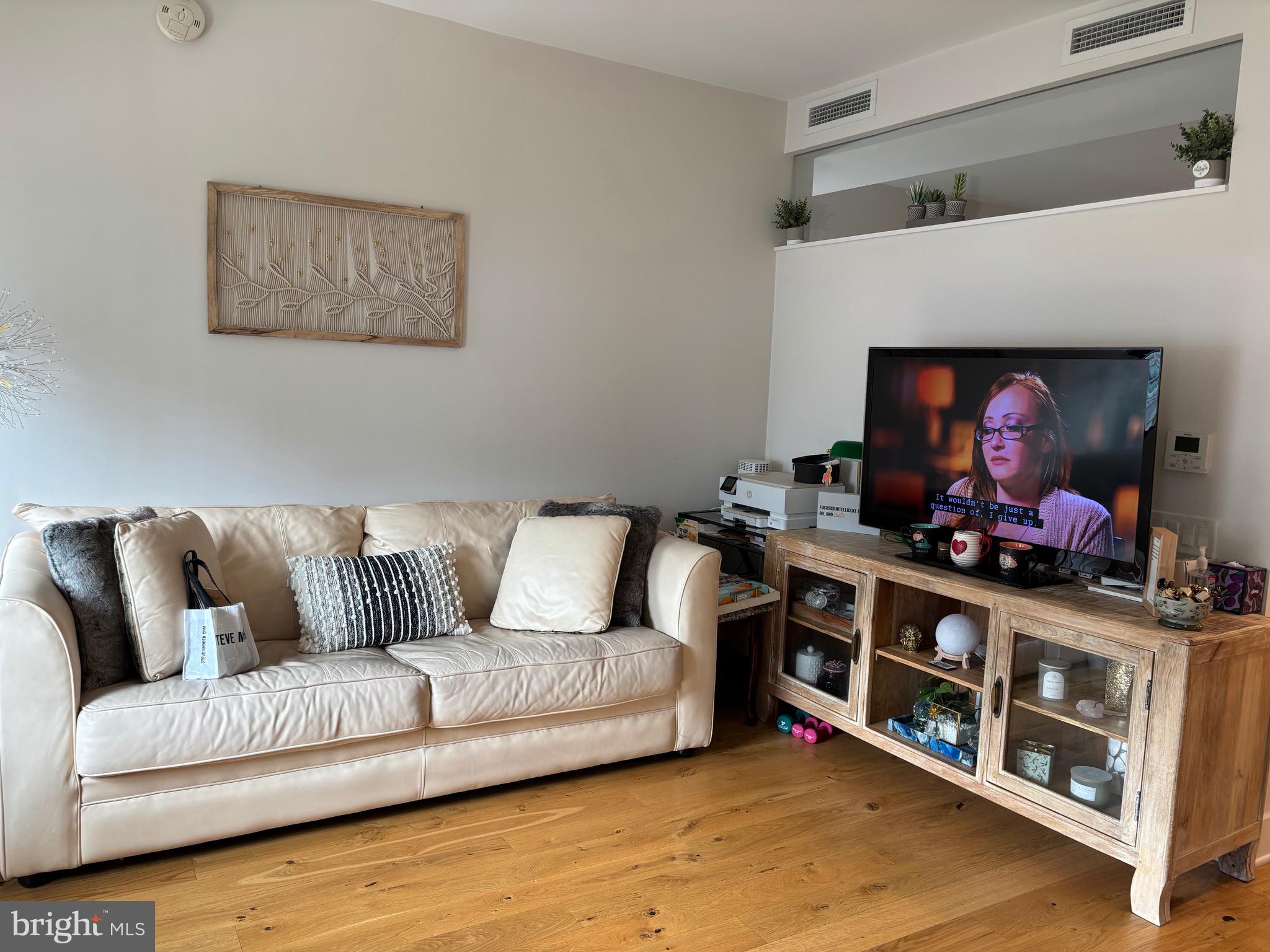1211 Van Street Southeast, Unit 310 Washington, DC 20003 - Photo 22 of 49 a living room with furniture and a flat screen tv