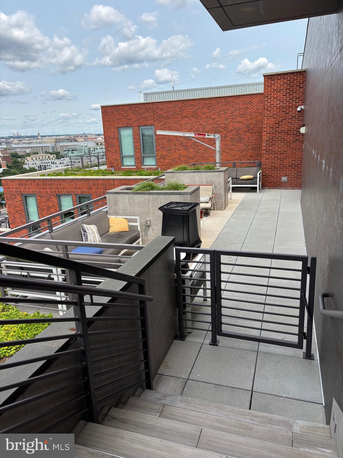 1211 Van Street Southeast, Unit 310 Washington, DC 20003 - Photo 41 of 49 a view of a balcony with two chairs and a barbeque