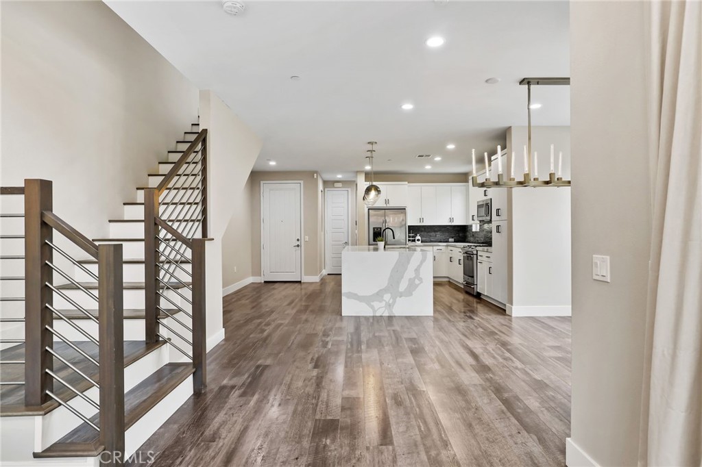 51 Prominence Lake Forest, CA 92630 - Photo 12 of 60 a large kitchen with white cabinets and stainless steel appliances