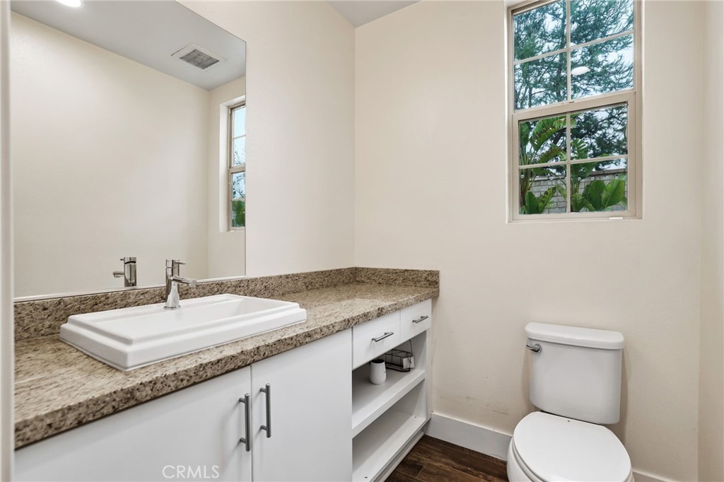 51 Prominence Lake Forest, CA 92630 - Photo 19 of 60 a bathroom with a granite countertop sink and a toilet