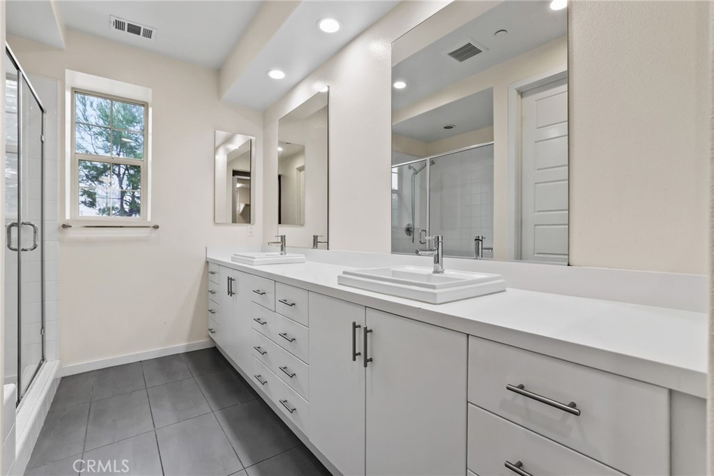 51 Prominence Lake Forest, CA 92630 - Photo 25 of 60 a bathroom with double sink and a mirror
