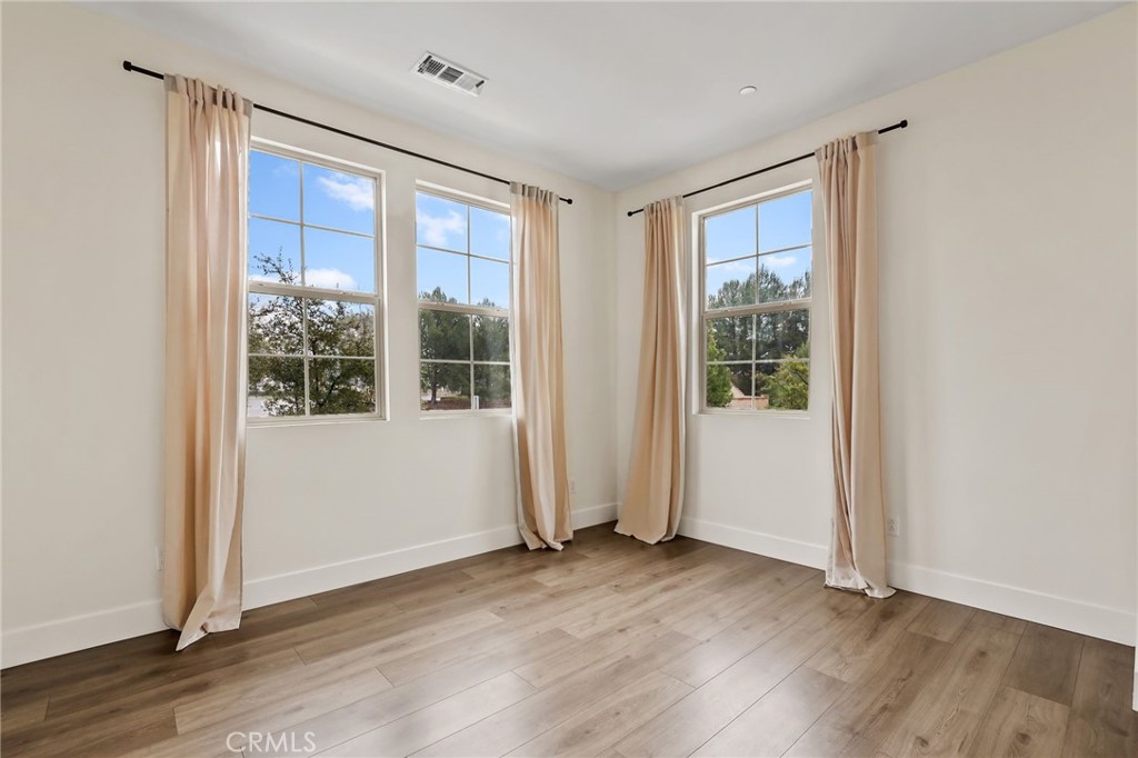 51 Prominence Lake Forest, CA 92630 - Photo 28 of 60 an empty room with wooden floor and windows