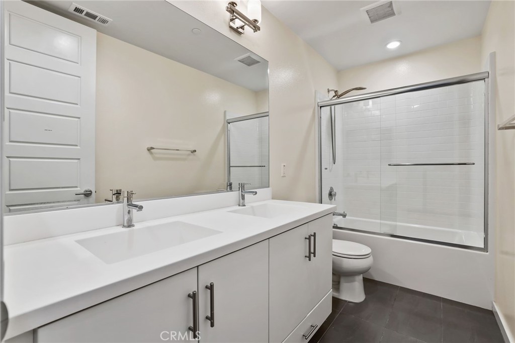 51 Prominence Lake Forest, CA 92630 - Photo 29 of 60 a bathroom with a sink toilet a mirror and shower