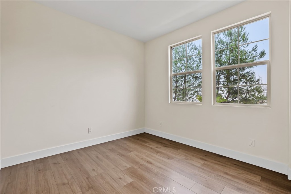 51 Prominence Lake Forest, CA 92630 - Photo 30 of 60 an empty room with wooden floor and windows