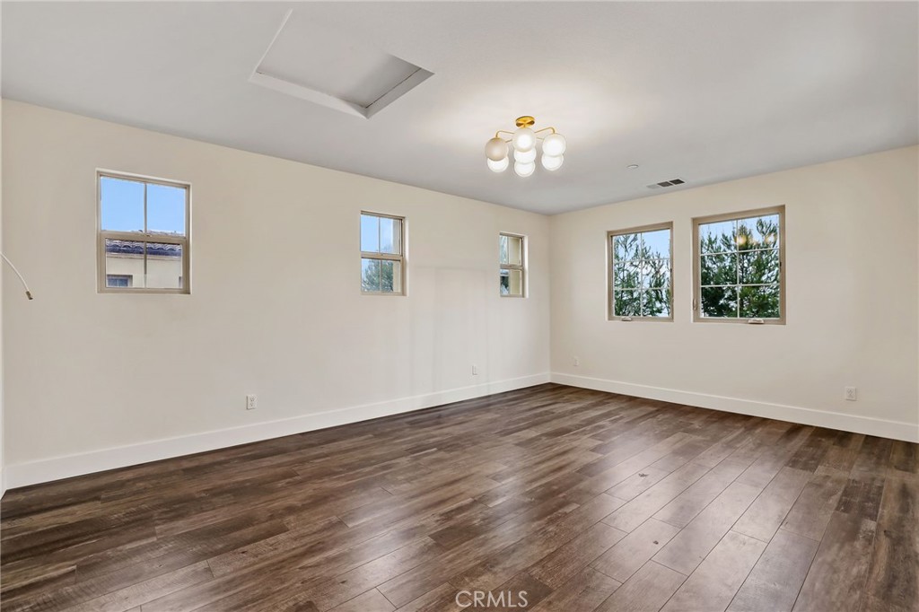 51 Prominence Lake Forest, CA 92630 - Photo 32 of 60 a view of an empty room with wooden floor and a window