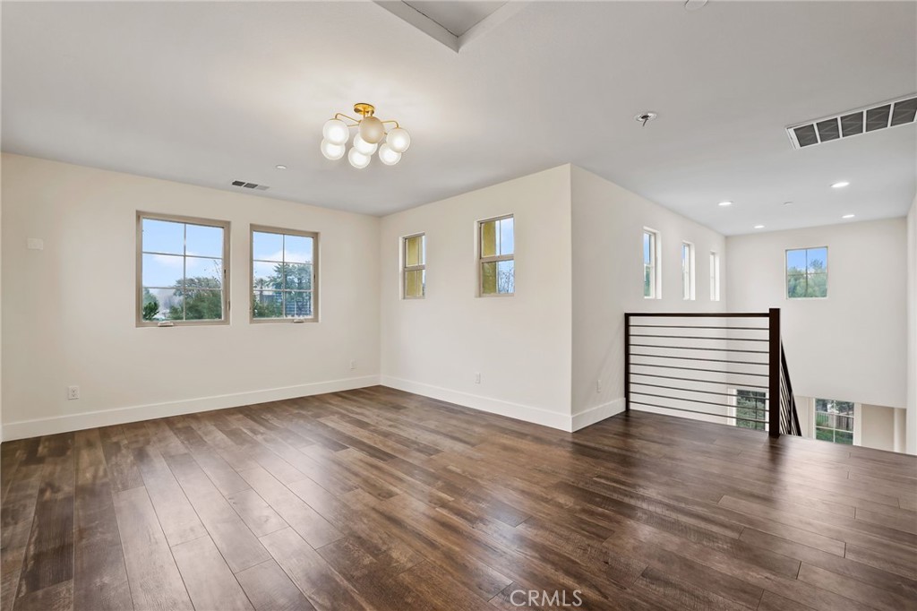 51 Prominence Lake Forest, CA 92630 - Photo 33 of 60 a view of an empty room with wooden floor and a window