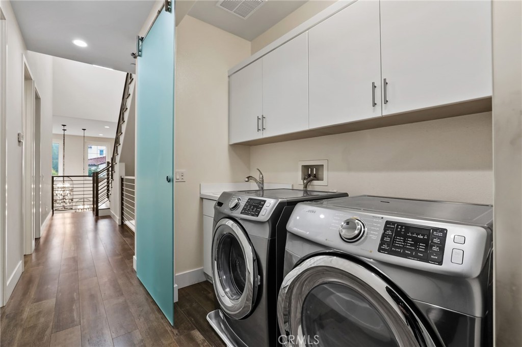 51 Prominence Lake Forest, CA 92630 - Photo 35 of 60 a view of washer and dryer with kitchen in the background