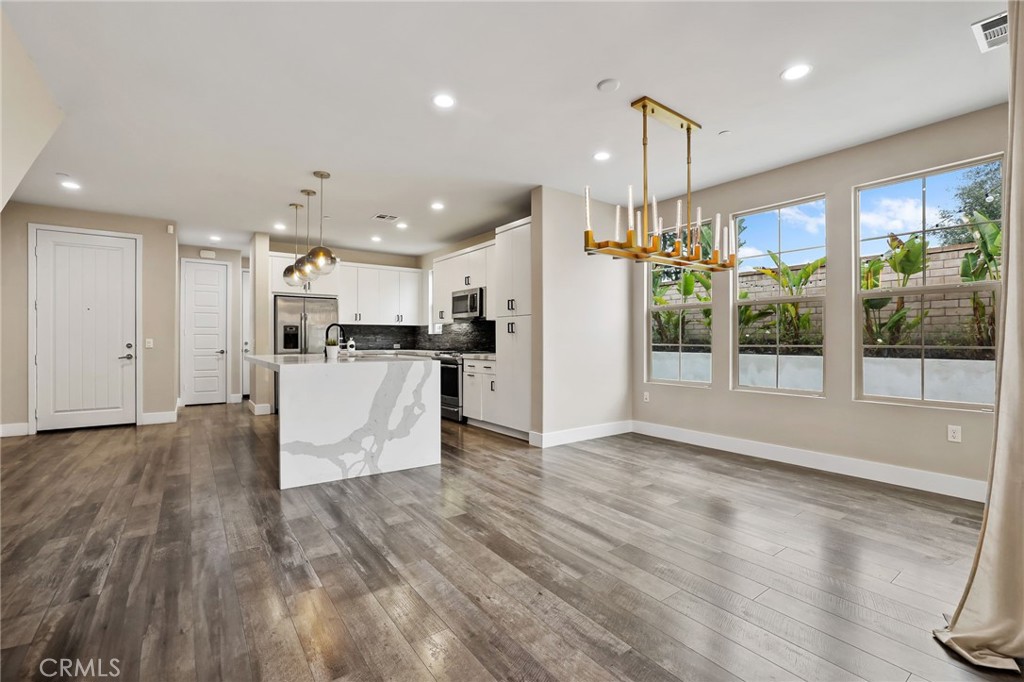 51 Prominence Lake Forest, CA 92630 - Photo 4 of 60 a view of a kitchen with kitchen island a counter space a refrigerator and a sink