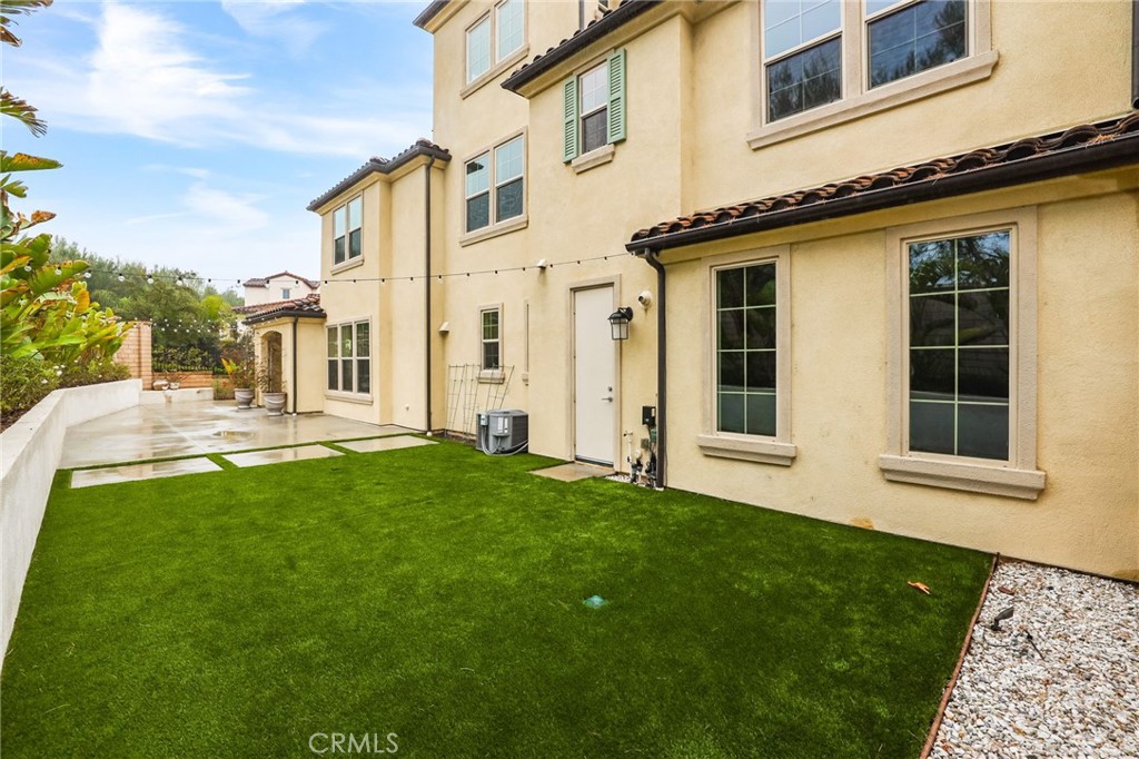 51 Prominence Lake Forest, CA 92630 - Photo 48 of 60 a view of a house with many windows and a yard