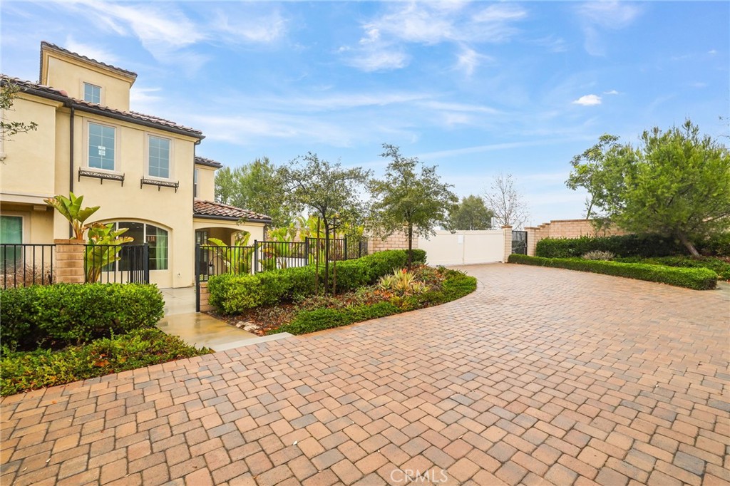 51 Prominence Lake Forest, CA 92630 - Photo 53 of 60 a front view of a house with a yard and potted plants