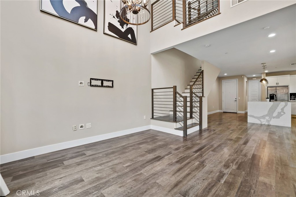 51 Prominence Lake Forest, CA 92630 - Photo 10 of 60 a view of an empty room with wooden floor and a ceiling fan