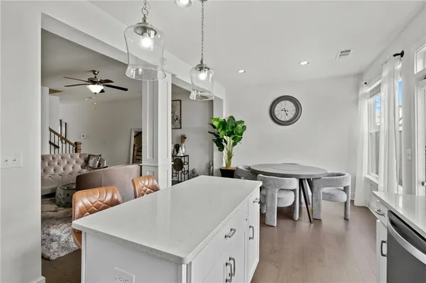 a view of a dining room with furniture and a potted plant