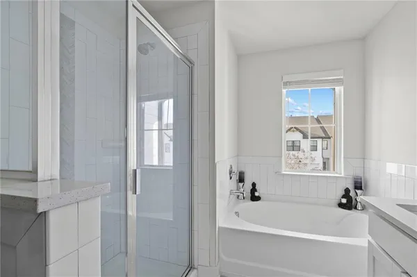 a bathroom with a bathtub and a shower