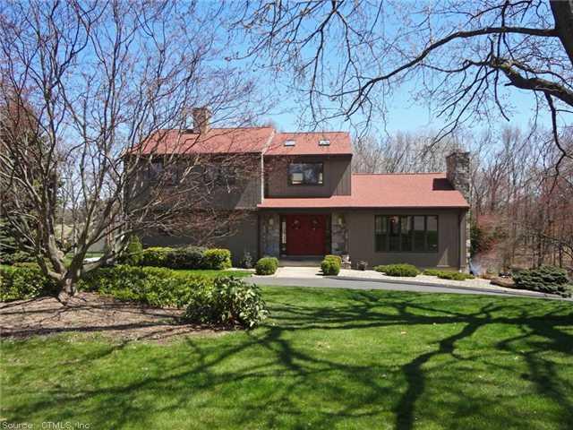 26 Sullivan Farm Road East Windsor, CT 06016 - Photo 1 of 1 a front view of a house with a garden and trees