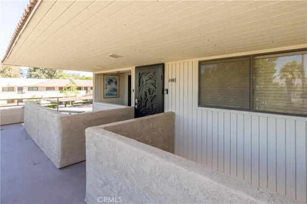 a living room with stainless steel appliances granite countertop furniture and a large window
