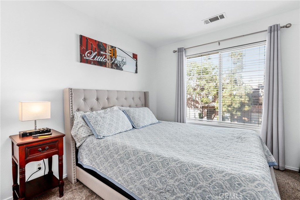 59 Red Bud Aliso Viejo, CA 92656 - Photo 20 of 34 a bedroom with a bed and a lamp on dresser